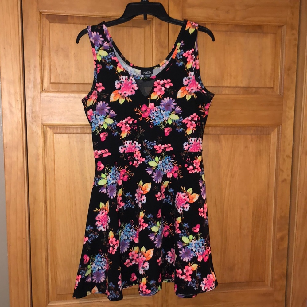 sleeveless dress. Eye catching black dress with vibrant neon floral print.